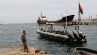 A Libyan coast guard member conducts a daily routine check on one of the patrol boats in Tripoli, April 19, 2016 (REUTERS / Ismail Zitouny) 