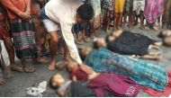  A Bangladeshi man touches the body of a Rohingya child on August 31, 2017, one of a number of people who drowned after their boat capsized on the Naf river estuary near Teknaf. At least 18,500 Rohingya have crossed into Bangladesh since fighting erupted 