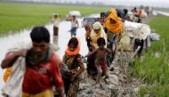 Rohingya refugees walk on the muddy path after crossing the Bangladesh-Myanmar border in Teknaf, Bangladesh, September 3, 2017. REUTERS/Mohammad Ponir Hossain
