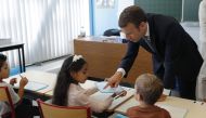 French President Emmanuel Macron speaks with pupils during a visit to a school at the start of the new school year in Forbach, eastern France on September 4, 2017. AFP / Philippe Wojazer