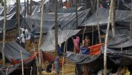 Rohingya refugees from Myanmar's Rakhine state shelter under makeshift tents after arriving at a refugee camp near the Bagladeshi town of Teknaf on Septebmer 5, 2017. (AFP / K M ASAD)