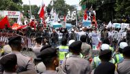 Muslim men protest against what they say is the persecution of the Rohingya Muslim minority in Myanmar, outside of Myanmar's embassy in Jakarta, Indonesia September 6, 2017. REUTERS/Darren Whiteside