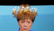 A chandelier hangs in front of a giant TV screen showing German Chancellor Angela Merkel going head-to-head with her fiery challenger Martin Schulz of teh Social Democratic party (SPD) in their only television debate before this month's general elections,