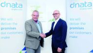 Senior officials of Siemens and dnata shaking hands.