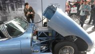 A visitor views a classic Jaguar E-Type modified with an electric engine on display at the Jaguar Land Rover 'Tech Fest' in London, September 7, 2017. REUTERS/Toby Melville