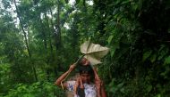 A Rohingya refugee man protects his sister from rain as he climbs down a hill after crossing the Bangladesh-Myanmar border in Cox's Bazar, Bangladesh September 8, 2017. Reuters/Danish Siddiqui

