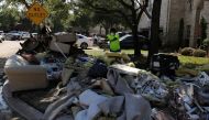 The contents of a flooded home are moved to the street in the aftermath of tropical storm Harvey in Katy, Texas, U.S., September 8, 2017. REUTERS/Mike Blake
