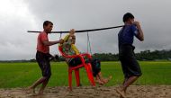 An old Rohingya Muslim being carried to safety.