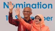 Singapore's President-elect Halimah Yacob and her husband Mohammed Abdullah Alhabshee address supporters before leaving the nomination centre in Singapore September 13, 2017. REUTERS/Edgar Su
