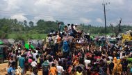 Rohingya refugees climb a truck to receive aid distributed by local organisations at Balukhali makeshift refugee camp in Cox's Bazar, Bangladesh, September 14, 2017. REUTERS/Danish Siddiqui
