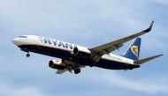 (FILES) This file photo taken on June 06, 2016 shows an airplane of the Irish low-cost airline Ryanair preparing to land at Barcelona's airport in El Prat de Llobregat.  AFP / JOSEP LAGO
