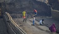 This photograph taken on September 18, 2017 shows Indian labourers working in a brick kiln on the outskirts of Jalandhar on September 18, 2017. AFP / SHAMMI MEHRA 

