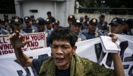 An activist shouts slogans during a protest against Philippine President Rodrigo Duterte in front of the Armed Forces of the Philippines (AFP) headquarters in Manila on September 21, 2017. AFP / NOEL CELIS

