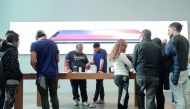 A customer purchases a new iPhone 8 at the Fifth Avenue Apple Store, September 22, 2017 in New York City. The new iPhone 8 and iPhone 8 Plus, as well as the updated Apple Watch and Apple TV, go on sale today. Drew Angerer/Getty Images/AFP