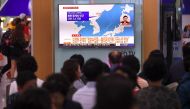People watch a television news screen showing a map of the epicenter of an earthquake in North Korea, at a railway station in Seoul on September 23, 2017. AFP / JUNG Yeon-Je
