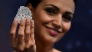 (FILES) This file photo taken on June 14, 2016 shows a model posing with an uncut 1109-carat diamond named 'Lesedi La Rona' at Sotheby's auction house in London. Graff diamonds have purchased the Lesedi La Rona diamond on September 26, 2017 for $53 millio