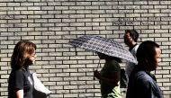 NEW YORK, NY: People walk along a Manhattan street on an unseasonably warm afternoon on September 25, 2017 in New York City. Spencer Platt/Getty Images/AFP