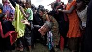 A Rohingya refugee reacts as people scuffle while waiting to receive aid in Cox's Bazar, Bangladesh, September 26, 2017. REUTERS/Cathal McNaughton.