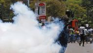 A supporter of the opposition National Super Alliance (NASA) coalition runs after riot policemen dispersed protesters during a demonstration calling for the removal of Independent Electoral and Boundaries Commission (IEBC) officials in Nairobi, Kenya Sept
