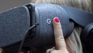 An attendee wears VR goggles at the Google digital workshop stand at the Labour Party Conference venue in Brighton, Britain, September 26, 2017. Reuters/Toby Melville