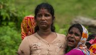 Hindu women cry near the dead bodies of their family members in YeBawKya village near Maungdaw, north of Myanmar's Rakhine state on September 27, 2017. AFP