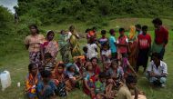Hindu people cry near the dead bodies of their family members in Yebawkya village, Maungdaw on September 27, 2017. Myanmar's army said on September 24, 2017 it had discovered a mass grave containing the bodies of 28 Hindus, including women and children, i