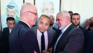 Hamas’ overall leader Ismail Haniyah (right) shakes hands with Palestinian Prime Minister Rami Hamdallah in Gaza City yesterday.