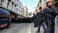 Catalan regional police officers, Mossos d'Esquadra, stand in front of a group of Spanish National Police officers who were shouting towards locals who were protesting the police presence outside their hotel in Pineda de Mar, north of Barcelona, Spain, Oc