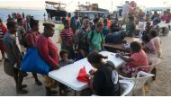 Residents evacuated due to the the Manaro Voui volcano, located on Vanuatu's northern island Ambae, register with authorities after disembarking from a boat at Luganville port, on Vanuatu's Espiritu Santos Island located in the South Pacific, October 3, 2