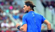 Alexander Zverev of Germany in action against Fabio Fognini of Italy in Beijing. RIGHT, BELOW: Rafael Nadal of Spain celebrates during his second-round match against Karen Khachanov of Russia.