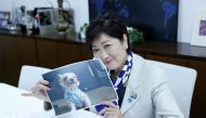 Tokyo Governor Yuriko Koike, head of Japan's Party of Hope, shows a picture of her pet dog named So-chan during an interview with Reuters in Tokyo, Japan October 6, 2017. Reuters/Issei Kato