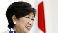 Tokyo Governor Yuriko Koike, head of Japan's Party of Hope, smiles next to a Japanese national flag during an interview with Reuters in Tokyo, Japan October 6, 2017. REUTERS/Issei Kato.
