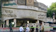 Syrian security forces stand guard outside the main entrance to the police headquarters in Syria's capital Damascus on October 11, 2017, following an attack the targeted the building. AFP / Louai Beshara