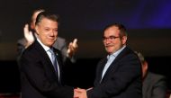 Colombia's President Juan Manuel Santos and Marxist FARC rebel leader Rodrigo Londono, known as Timochenko, shake hands after signing a peace accord in Bogota, Colombia November 24, 2016. REUTERS/Jaime Saldarriaga.