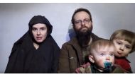 A still image from a video posted by the Taliban on social media on December 19, 2016 shows American Caitlan Coleman (L) speaking next to her Canadian husband Joshua Boyle and their two sons. Courtesy Taliban/Social media via Reuters