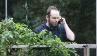 Freed Canadian hostage Joshua Boyle talks on the phone outside the Boyle family home in Smiths Falls, Ontario, Canada, on October 14, 2017. AFP / Mike CARROCCETTO