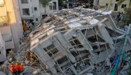 Police and rescue workers look for survivors in the rubble at the site of a collapsed under construction building in Bengaluru, India, October 5, 2016. REUTERS/Abhishek N. Chinnappa.