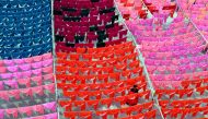 A worker hangs clothes to dry on the roof of a garment factory in Dhaka in this June 15, 2005 file photo.  Reuters / Rafiqur Rahman
