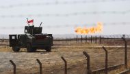 A picture shows an Iraqi army vehicle at the country's Bai Hassan oil field west of Kirkuk on October 17, 2017. Iraqi forces took control of the two largest oil fields in the disputed northern province of Kirkuk demolishing Kurdish hopes of creating a via