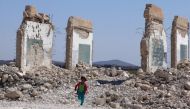 A girl runs near a damaged site in the Quneitra countryside, Syria September 12, 2017. REUTERS/Alaa Al-Faqir