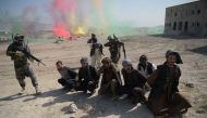 Afghan National Army (ANA) commandos arrest men pretending to be Taliban fighters during a military exercise at the Kabul Military Training Centre (KMTC) on the outskirts of Kabul on October 17, 2017. AFP / SHAH MARAI
