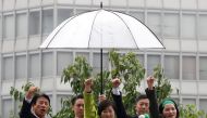 Head of Japan's Party of Hope and Tokyo Governor Yuriko Koike (C) and her party lawmakers raise their fists during the last day of campaigning for the October 22 lower house election, in Tokyo, Japan October 21, 2017. REUTERS/Issei Kato 