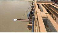 Automated water gauge that helps predict flood is fixed to a bridge over a river in Cambodia. 