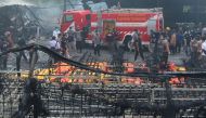 Indonesian forensic policemen work after a fire disaster in Tangerang Kota, Banten province on October 26, 2017. / AFP.