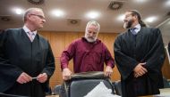 (FILES) This file photo taken on October 18, 2017 shows defendant Daniel Moser (C) flanked by his lawyers Hannes Linke (L) and Robert Kain (R) as he arrives for the opening of his trial at court in Frankfurt am Main, western Germany.  AFP / POOL / Andreas