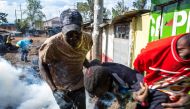 A wounded protester is carried away during clashes between opposition supporters and Kenyan police at the Kibera slum in Nairobi on October 26, 2017, after trying to block Olympic Primary polling station during Kenya's re-election voting.  AFP / Patrick M