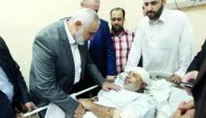 Hamas chief Ismail Haniyah visits injured Tawfeeq Abu Naeem at Al Shifa hospital in Gaza City, yesterday.