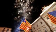 Catalan separatist flags are held up as fireworks go off in Sant Jaume Square in front of the Catalan regional government headquarters during celebratrions after the Catalan regional parliament declared independence from Spain in Barcelona, Spain, October