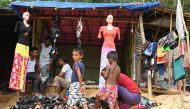 Rohingya refugee sell clothes at Kutupalong refugee camp in the Bangladeshi district of Ukhia on October 28, 2017. AFP / TAUSEEF MUSTAFA
