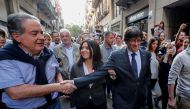 Sacked Catalan President Carles Puigdemont (R) walks with his wife Marcela Topor as he greets a supporter after leaving a restaurant the day after the Catalan regional parliament declared independence from Spain in Girona, Spain, October 28, 2017. Reuters